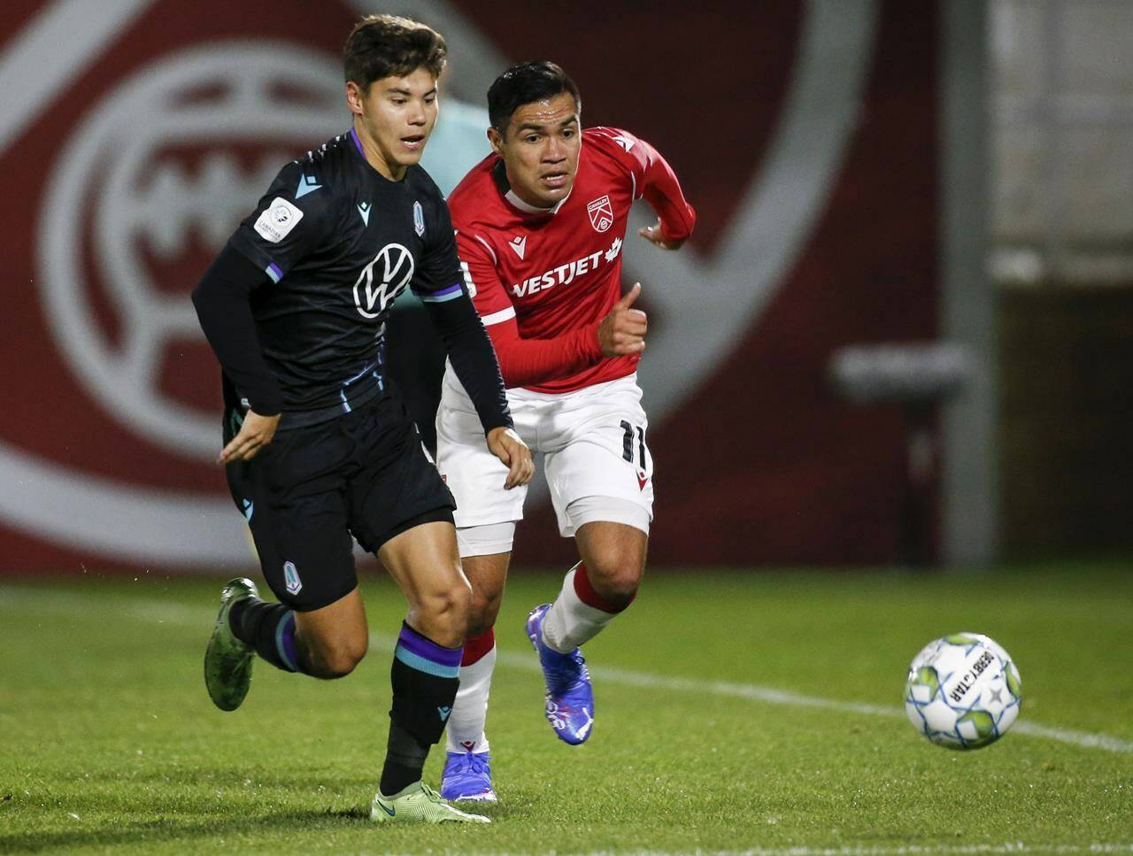 Pacific FC struggled against Cavalry FC on May 1. In this file photo, Pacific FC’s Kadin Chung, left, and Cavalry FC’s Jose Escalante chase the ball during the 2021 Canadian Championship quarterfinal in Calgary. (THE CANADIAN PRESS/Jeff McIntosh)