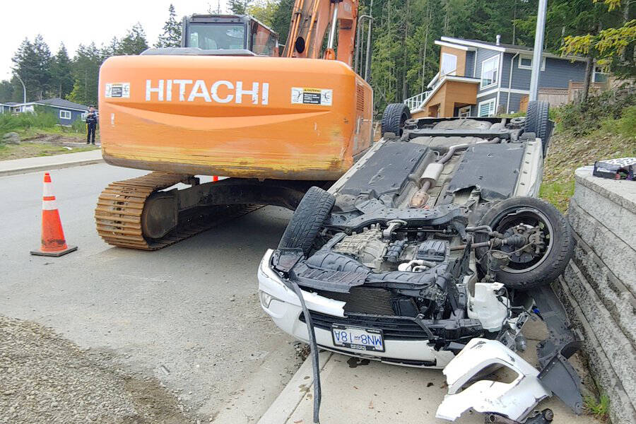 A driver lost control, clipped an excavator and rolled a vehicle on Ambience Drive in north Nanaimo on Tuesday, May 3. (Chris Bush/News Bulletin)