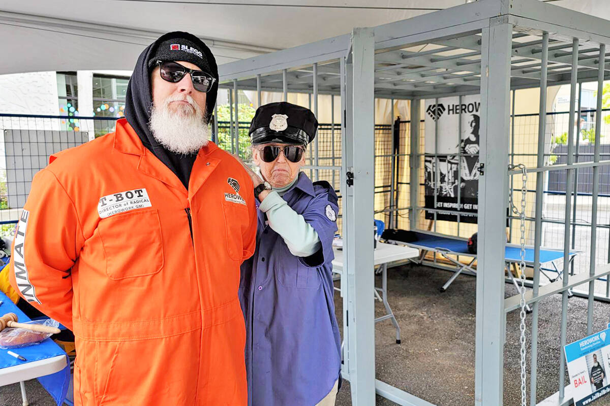 HeroWork Victoria general manager Trevor Botkin gets strong-armed into his jail cell at Uptown in Saanich as he starts the third annual Jail, Bail or Bribe fundraiser. The event runs through the weekend and the public can make a donation onsite, or online at jailbailbribe.com. (Photo courtesy HeroWork Victoria)