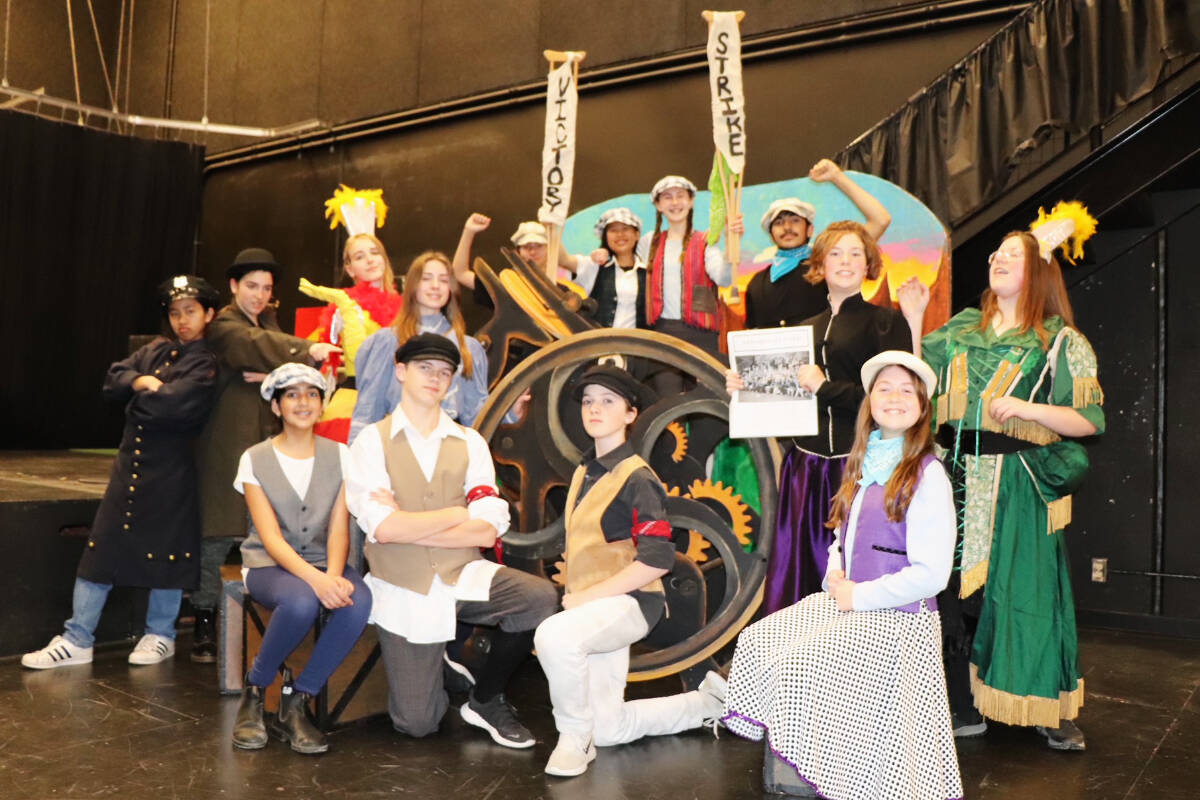 Lead cast members for the upcoming Colquitz middle school production of Newsies gather around some set pieces, including an articulating printing press. (Don Descoteau/News Staff)