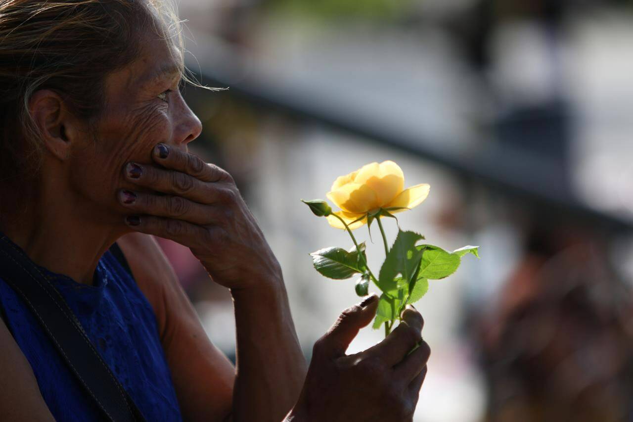 Catherine McCarthy-Martin holds a yellow rose in honour of her niece Chantel Moore during a healing gathering at the B.C. legislature in Victoria on Thursday, June 18, 2020. A jury of three women and two men has been chosen in the coroner’s inquest into the death of Chantel Moore — a 26-year-old Indigenous woman fatally shot by police in Edmundston, N.B., during a wellness check on June 4, 2020. THE CANADIAN PRESS/Chad Hipolito