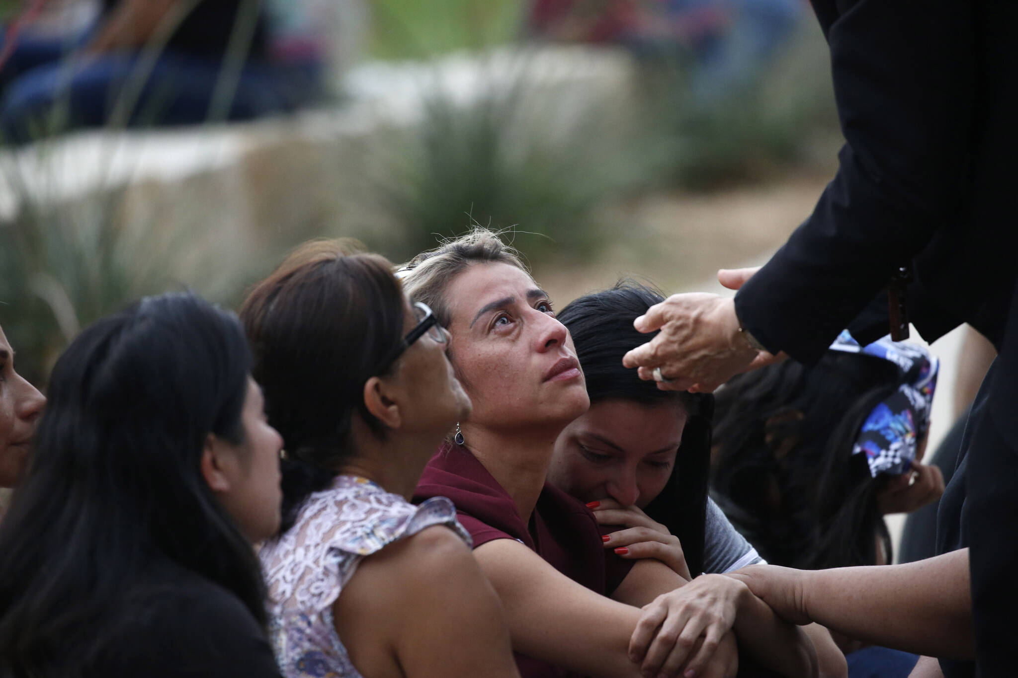 The Archbishop of San Antonio, Gustavo Garcia Seller comforts families outside of the Civic Center in Uvalde, Texas Tuesday, May 24, 2022. (AP Photo/Dario Lopez-Mills)