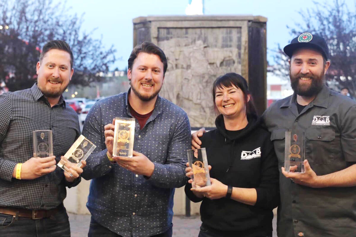 Corey Bradder, left, and Aaron Colyn show off Twin City Brewing’s national awards, while Robin Miles and Andy Richards hold up their hardware from the recent Canadian Brewing Awards. (Courtesy of Twin City Brewing)