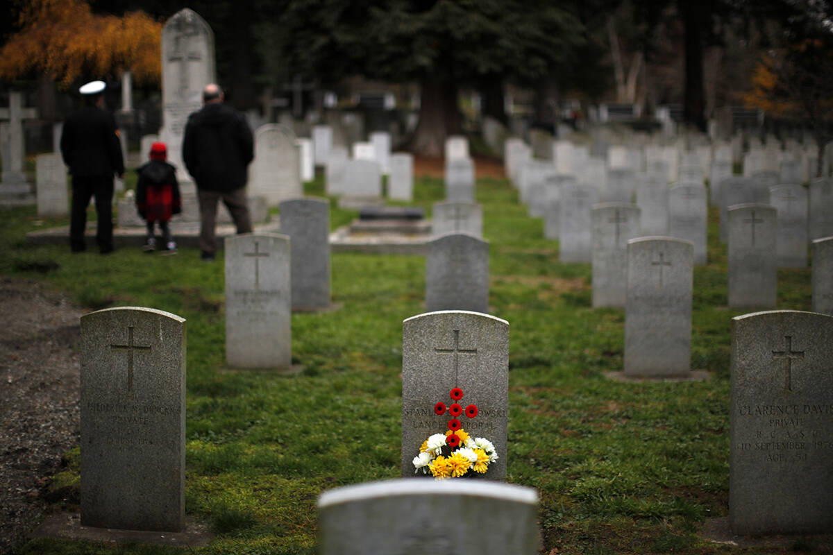 People gather to honour the fallen during a Remembrance Day ceremony at God’s Acre. A candlelight vigil will be held at the cemetery May 26 starting at 6:45 p.m. (THE CANADIAN PRESS/Chad Hipolito file photo)
