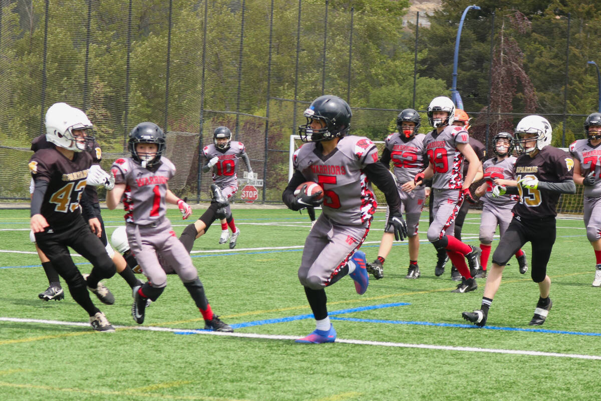 Players from the Westshore Warriors and the Victoria Spartans (black) play a football match on Goudy Field on May 29, 2022. (Bailey Moreton/News Staff)