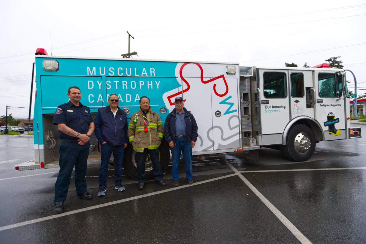 Colwood Fire Rescue members Tim Yeo, Deputy Chief Greg Chow, Norm Choo, and Ron Aubrey stand in front of the work-in-progress Muscular Dystrophy Canada fire truck Saturday May 28 during a fill the boot fundraising campaign in Colwood. (Justin Samanski-Langille/News Staff)