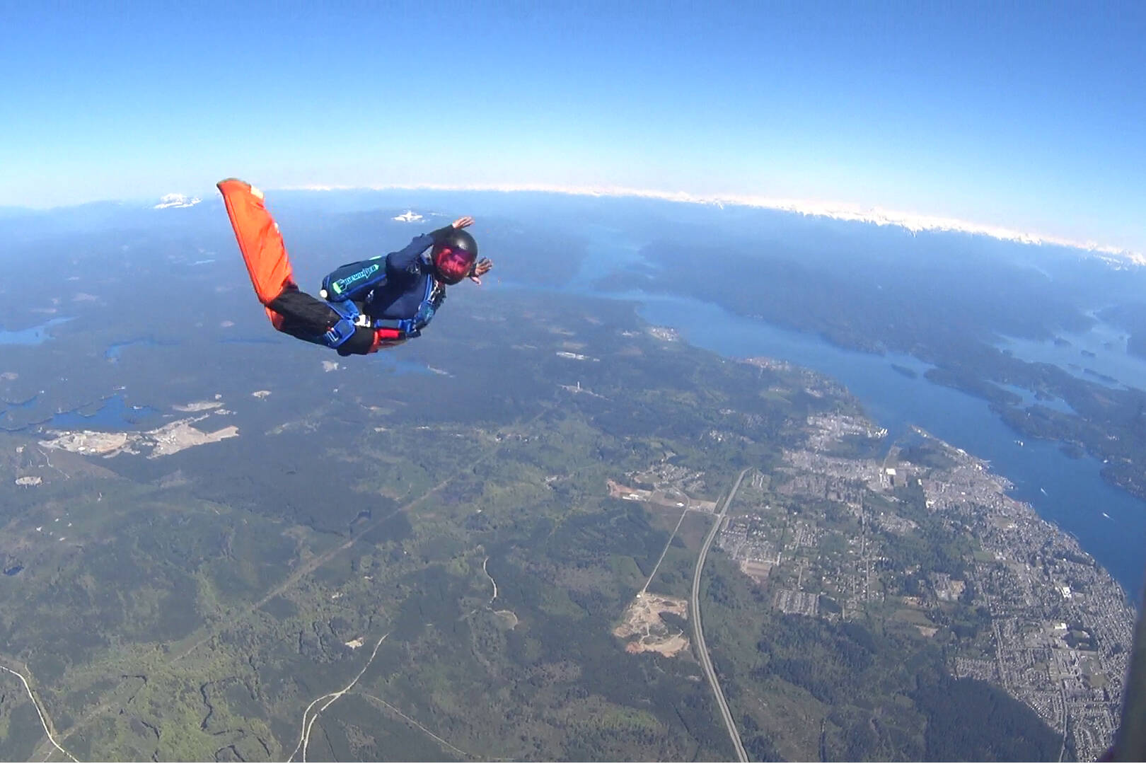 Corina Jones (parachute rigger and part of the Flying High Manufacturing build team) jumps from a helicopter over Campbell River on Saturday, May 21. Contributed photo