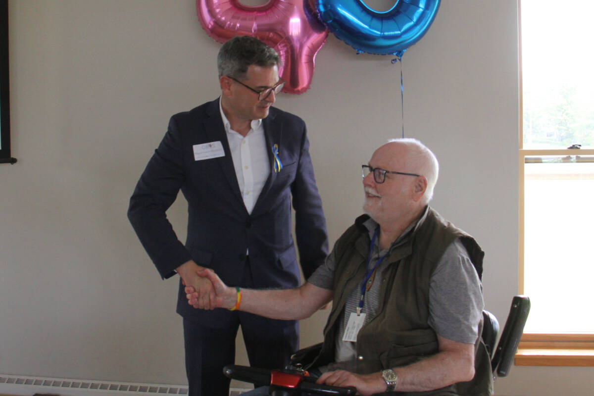 Oak Bay Mayor Kevin Murdoch thanks John Hurlburt for his 35 years of volunteering with Oak Bay Volunteer Services Society (Christine van Reeuwyk/News Staff)