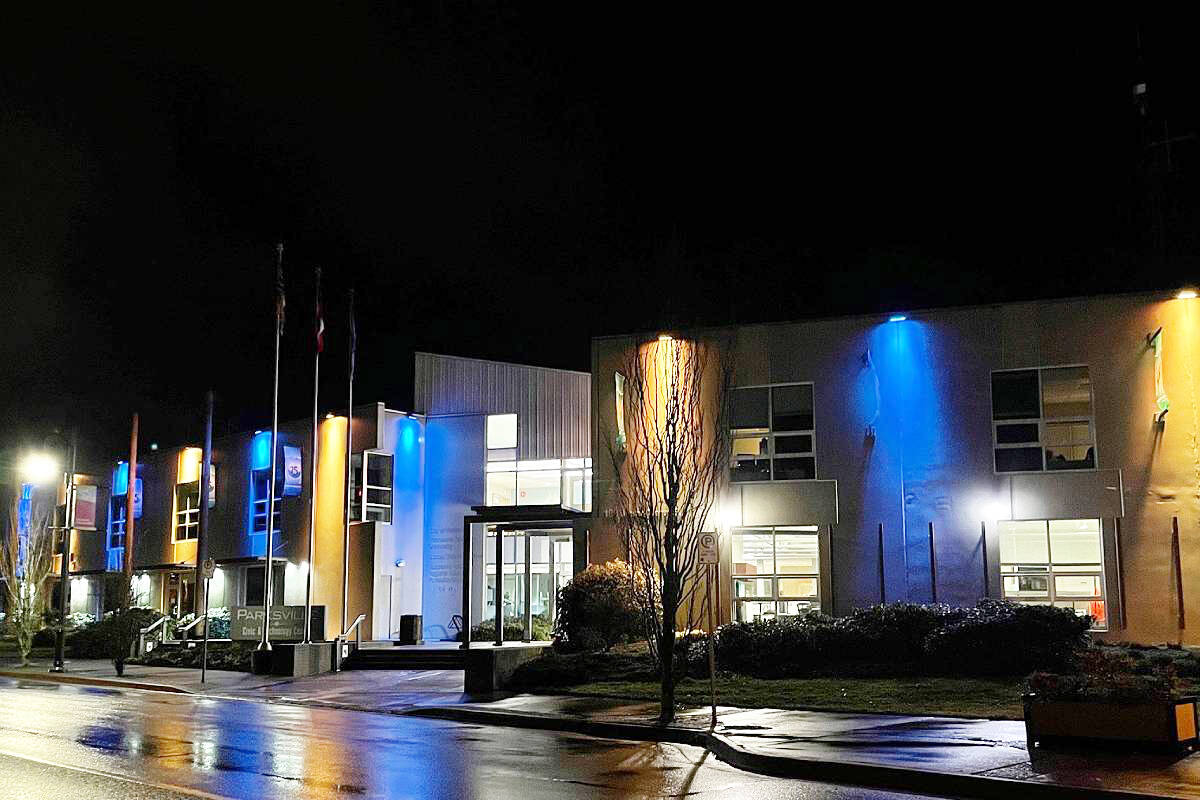 A social media post by the City of Parksville, dated March 1, 2022, shows the Civic and Technology Centre (100 Jensen Ave.) lit up in the colours of the Ukraine flag. (Facebook photo)