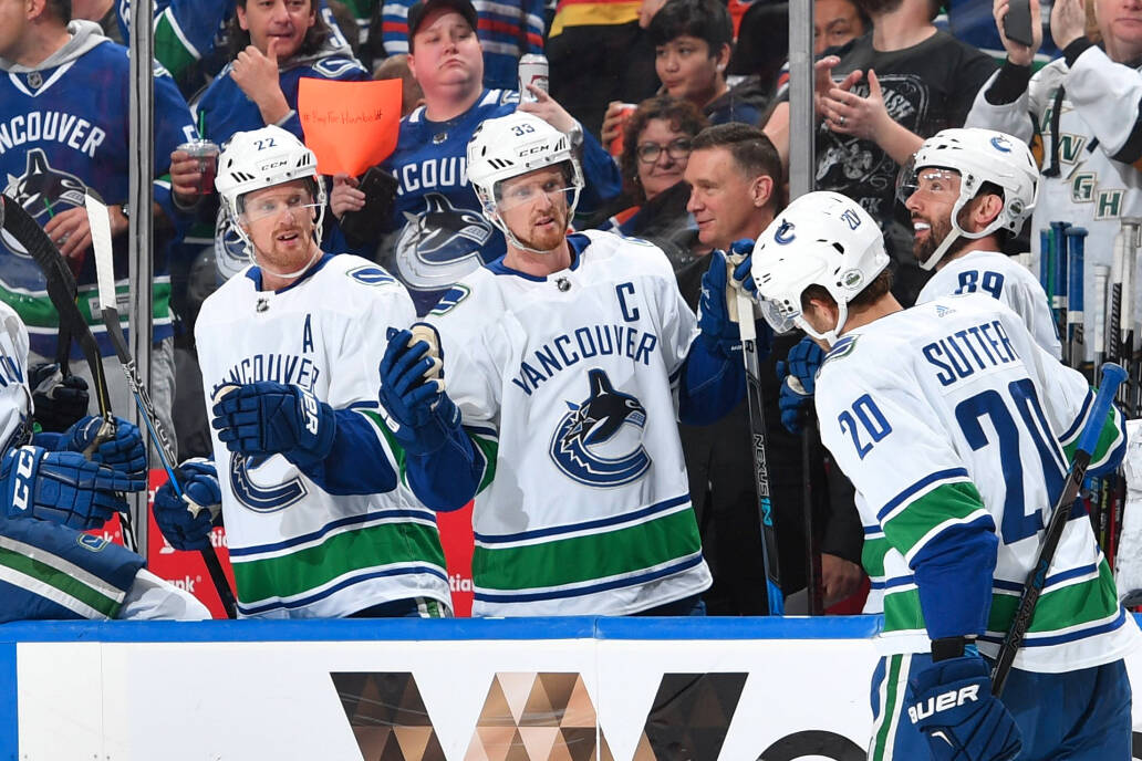 Canucks Henrik and Daniel Sedin celebrate on from the bench. Photo: Twitter