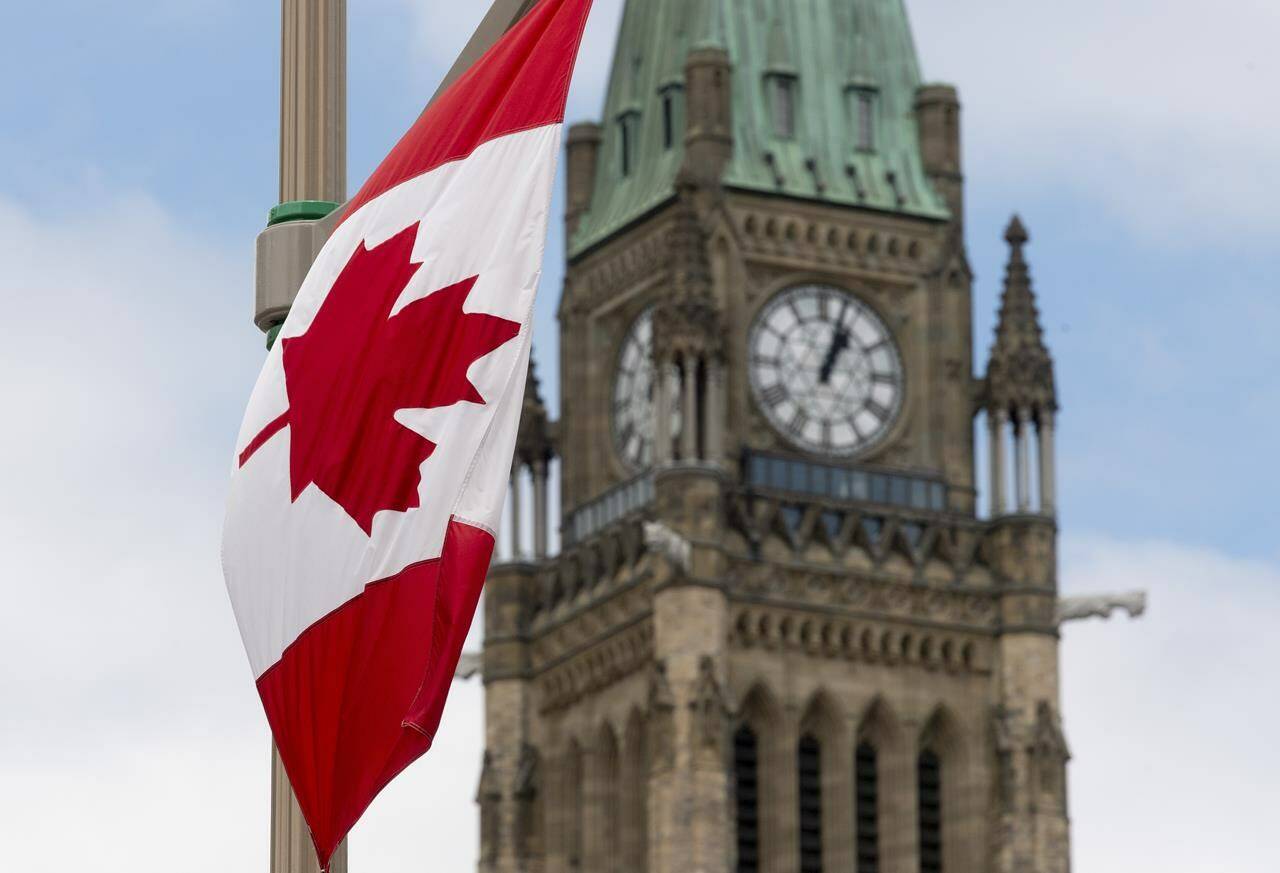 A Canadian flag hangs from a lamp post along the road in front of the Parliament buildings in Ottawa, June 30, 2020. (Photo: The Canadian Press/Adrian Wyld).