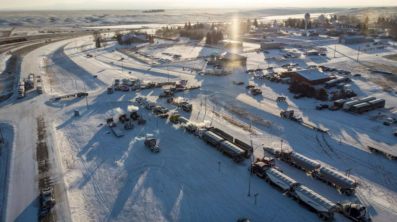 A truck convoy of anti-COVID-19 vaccine mandate demonstrators blocked the highway at the busy U.S. border crossing in Coutts, Alta., on February 2, 2022. A judge has reserved her decision on whether to grant bail for the fourth man charged with conspiracy to commit murder at a border blockade earlier this year in southern Alberta. Jerry Morin, 40, attended the two-day hearing in Lethbridge, Alta., by video. Queen’s Bench Justice Johnna Kubik says she would give her ruling on July 18. THE CANADIAN PRESS/Jeff McIntosh