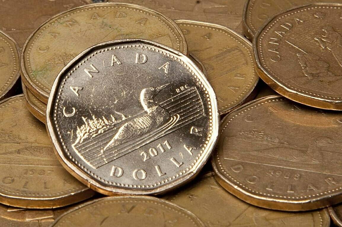 Canadian loonie coins are pictured in Vancouver, Sept. 22, 2011. Money is still considered a taboo topic or private matter, which is why many people avoid sparking up conversations about their personal finances with friends, colleagues and even family. THE CANADIAN PRESS/Jonathan Hayward