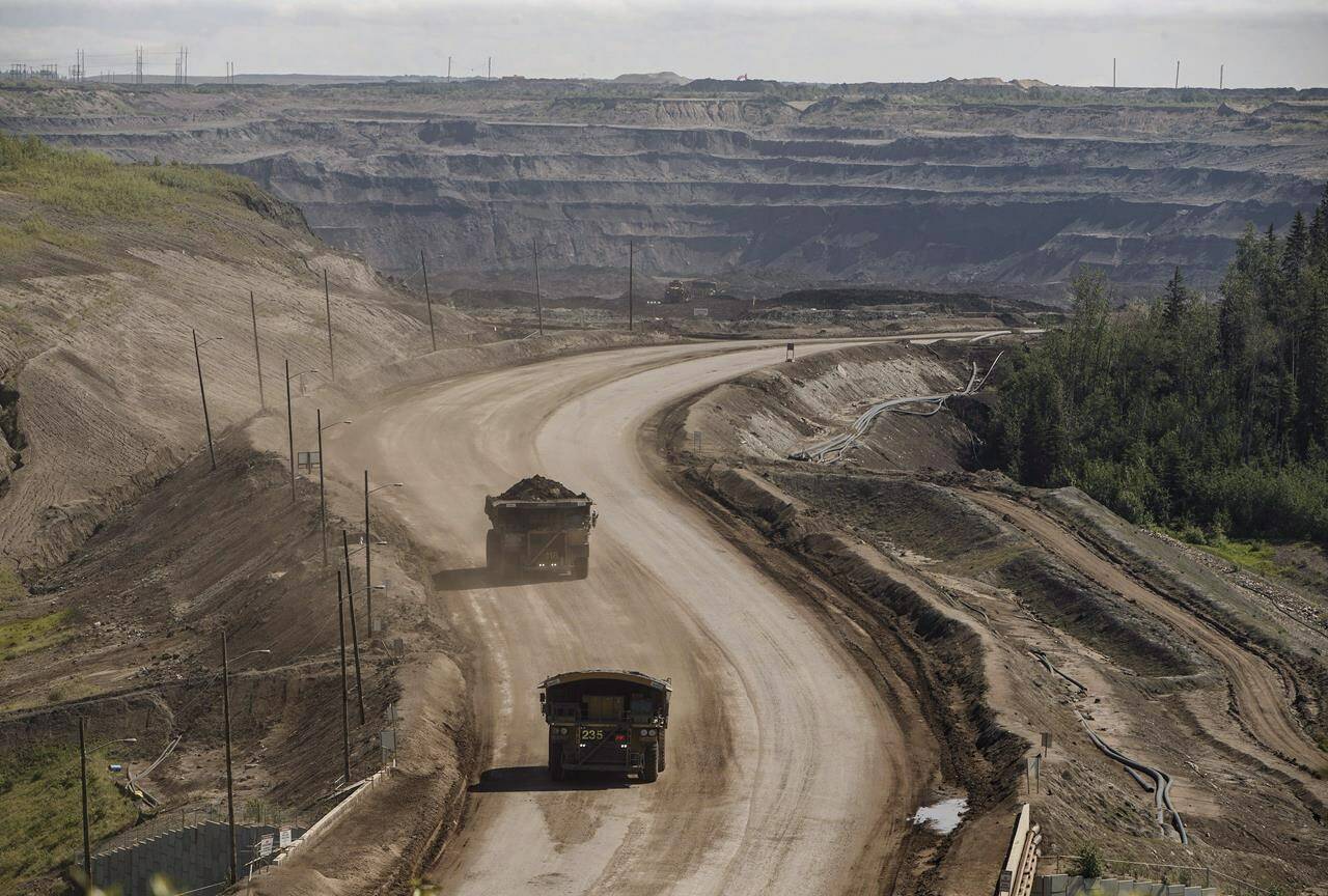 A heavy hauler trucks transports material from Suncor’s North Steepbank Mine in the oilsands in Fort McMurray Alta, on Monday June 13, 2017. Oilsands companies are exploring the possibility of deploying small modular nuclear reactors to create the heat needed in oilsands mining. THE CANADIAN PRESS/Jason Franson