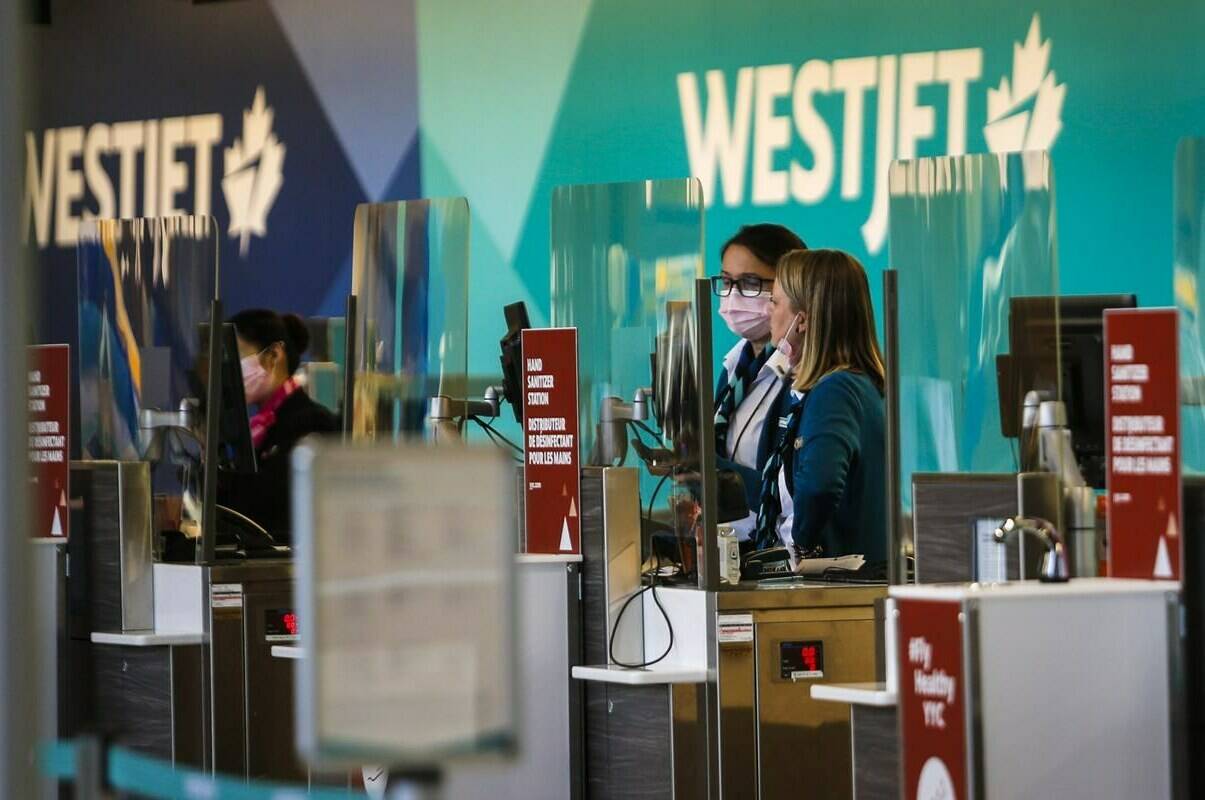 The union representing more than 700 WestJet employees at airports in Calgary and Vancouver say they have voted to support a strike if they cannot reach a new contract with the airline. Westjet employees wearing masks wait for passengers at the Calgary Airport in Calgary, Alta., Friday, Oct. 30, 2020. THE CANADIAN PRESS/Jeff McIntosh