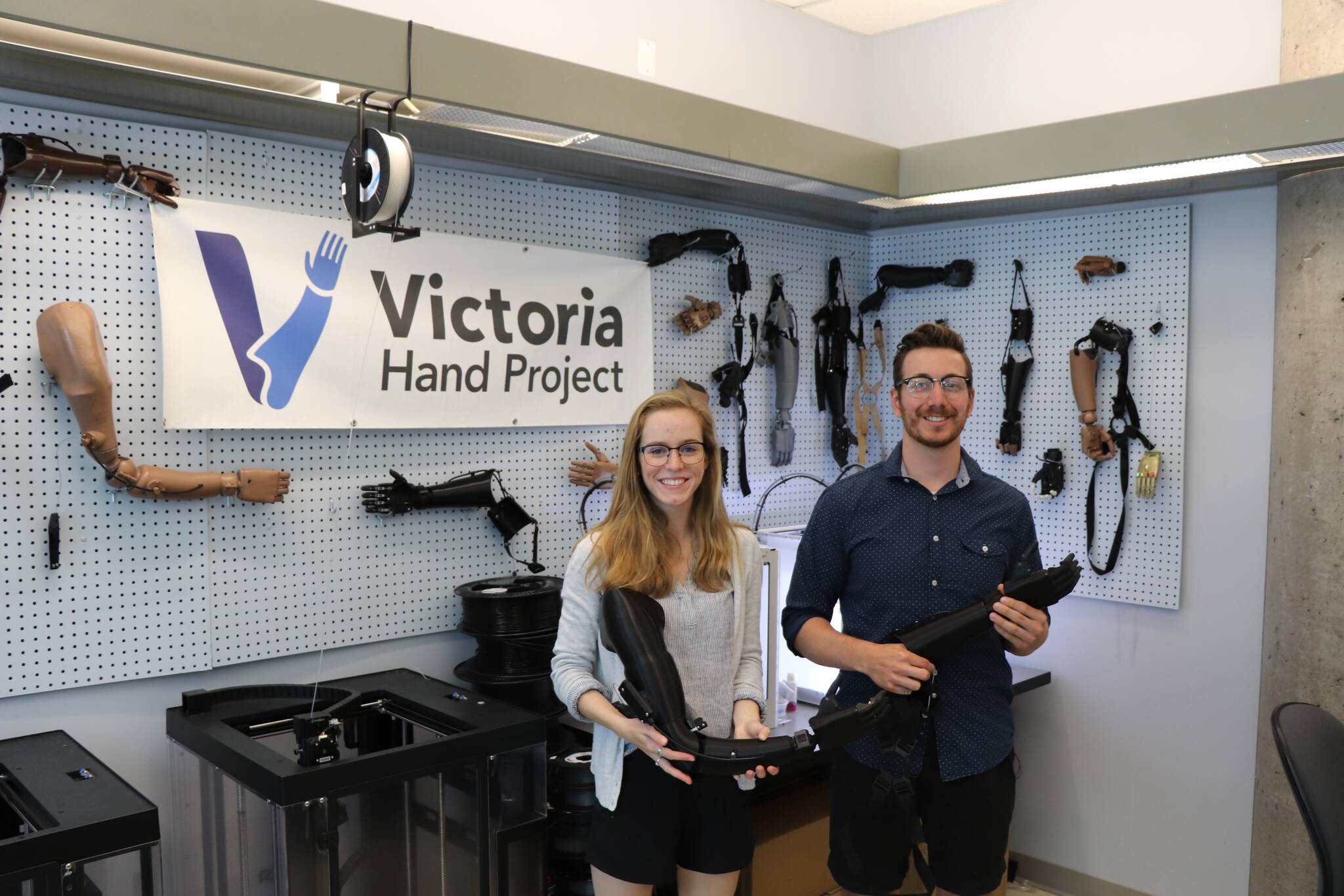 Victoria Hand Project CEO Michael Peirone and mechanical systems designer Kim Arklie hold 3D-printed prosthetic arms similar to those distributed worldwide by the UVic-based non-profit. (Austin Westphal/News Staff)