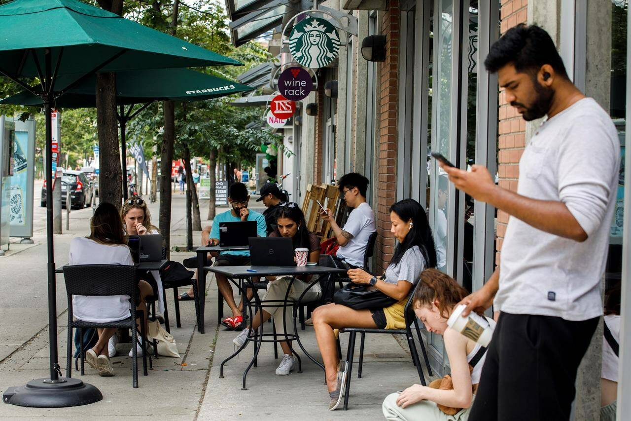 The House of Commons industry committee will hold two hearings today about the Rogers outage that lasted more than 15 hours and left millions of Canadians in a communications blackout. People use Starbucks’ provided WIFI at a store in Toronto amid a nationwide Rogers outage, affecting many of the telecommunication company’s services, Friday, July 8, 2022. THE CANADIAN PRESS/Cole Burston