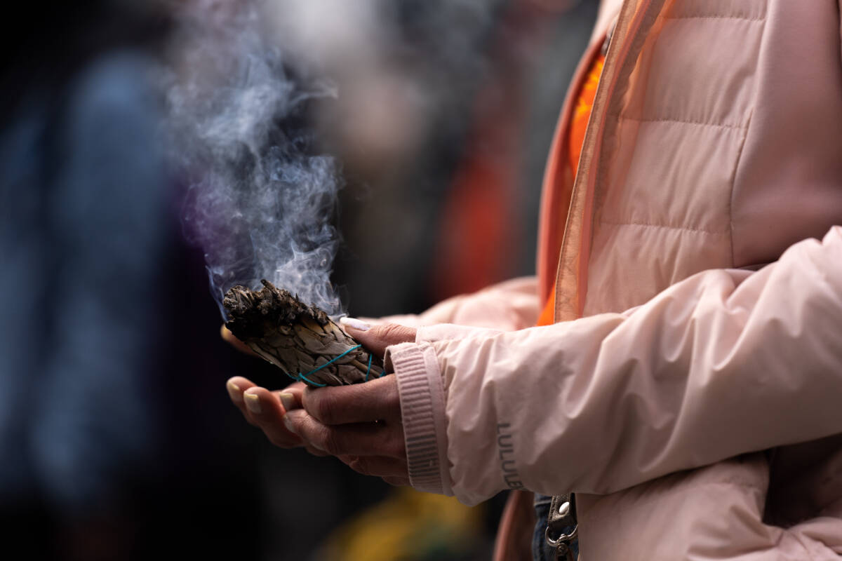 A woman holds a smudge stick. THE CANADIAN PRESS/Yader Guzman