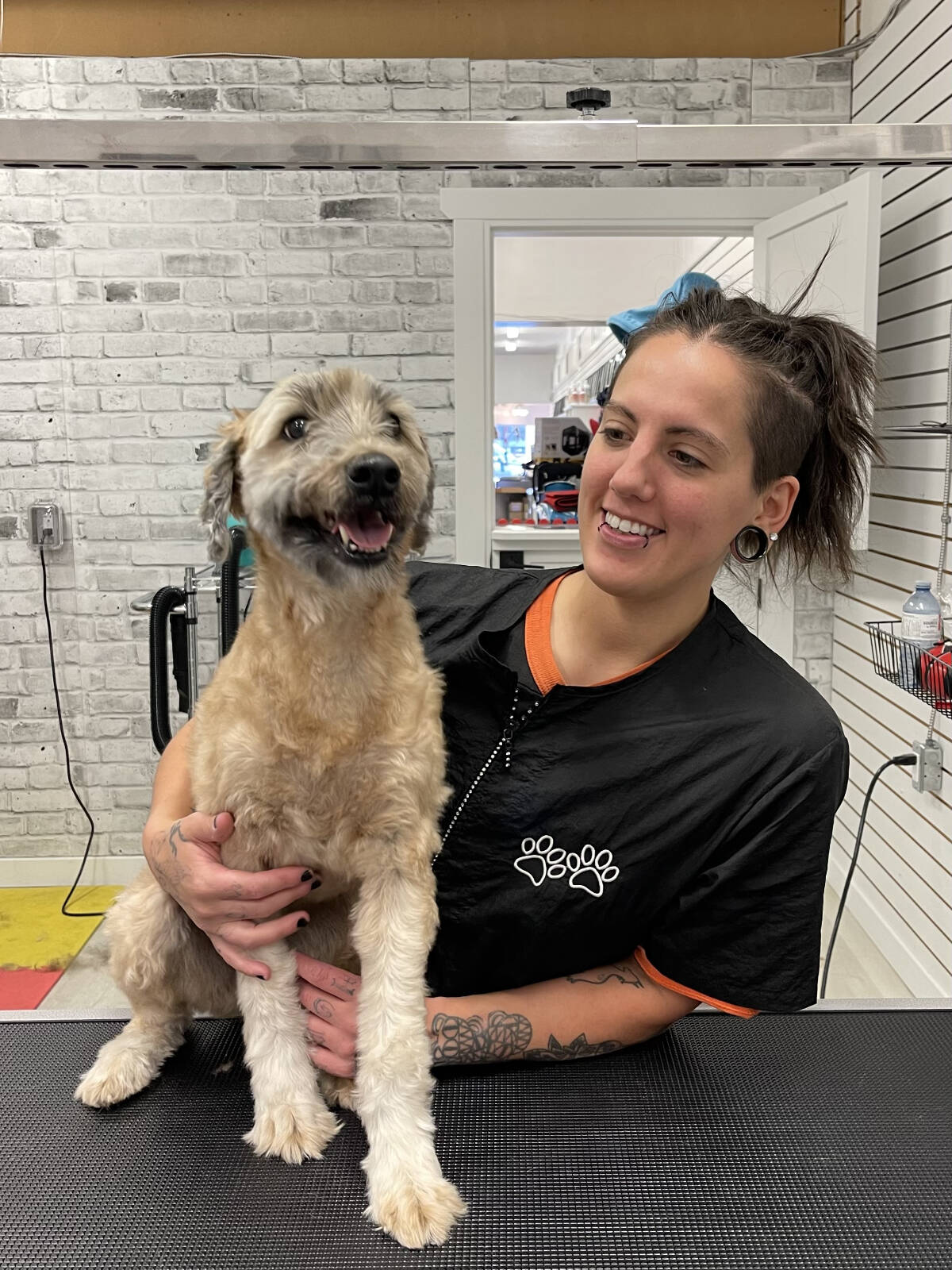 Pet Connection Sidney groomer Holly Worobec with happy client Caleigh. (Photo by Missy Costa)