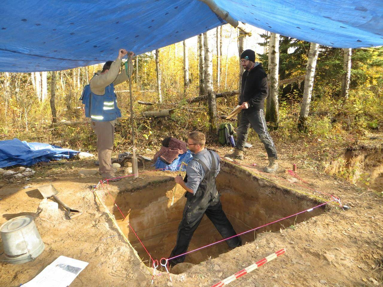 Reid Graham (left to right) of the Manitoba Historic Resources Management Branch, Todd Kristensen of the Archaeological Survey of Alberta and Robin Woywitka of MacEwan University excavate an archeological dig in the Fort McMurray, Alta., area in a handout photo. THE CANADIAN PRESS/HO-Brittany Romano **MANDATORY CREDIT**