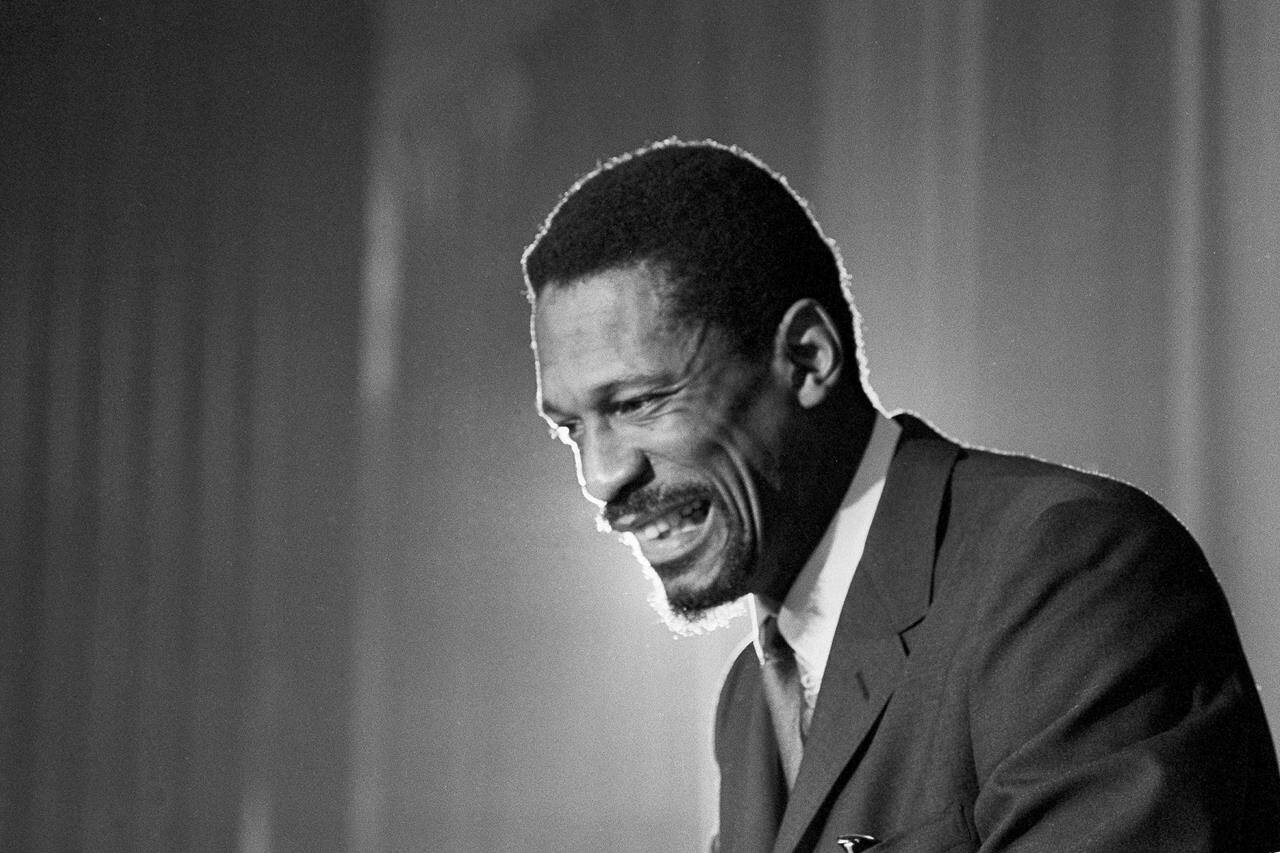 FILE - Bill Russell grins at announcement that he had been named coach of the Boston Celtics basketball team, April 18, 1966. (AP Photo, File)