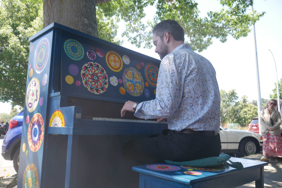 Musician Jesse Thomas Brown performs on Oak Bay’s sixth painted piano, in Estevan Village on a recent Friday afternoon. Community members of all ages decorated the instrument by collaging mandalas they painted. (Evert Lindquist/News Staff)