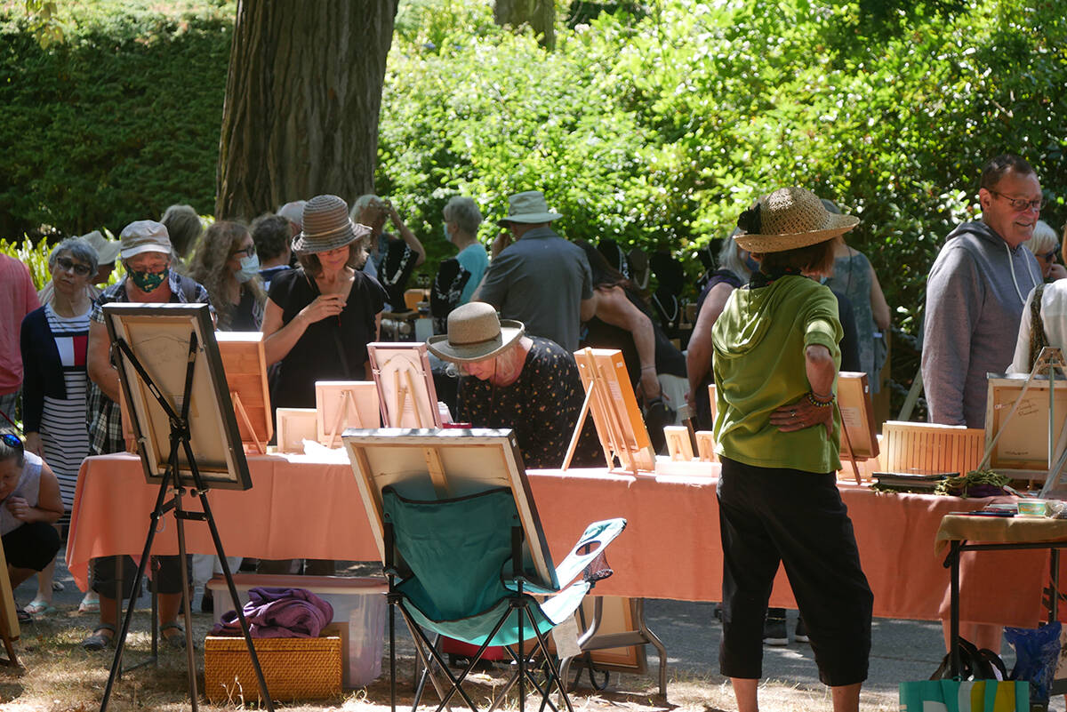 Visitors admire artists’ work at last year’s Bowker Creek Brush Up. This summer’s 17th annual outdoor show and sale happens Aug. 14 and feature artists of varying ages. (Black Press Media file photo)