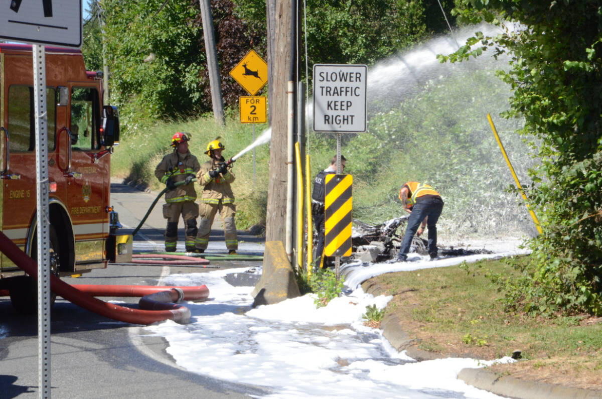 Members of Courtenay Fire Department put out the last of a motorcycle fire in the Mission hill area Saturday afternoon. Photo by Mike Chouinard