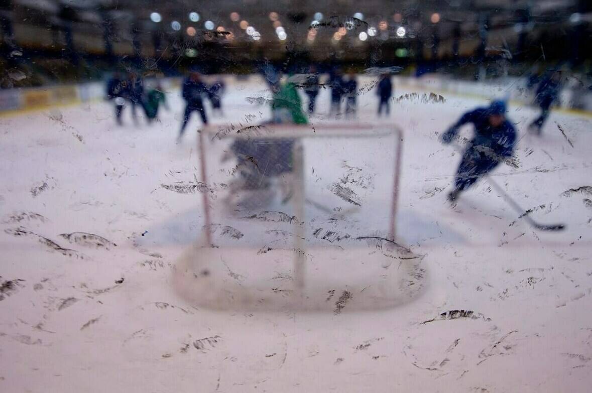Rubber marks from pucks dot the glass during a hockey practice in Vancouver on June 2, 2011. A majority of Canadians believe sexual harassment and sexual assault are a major problem in youth hockey are a major problem, according to an Angus Reid study. THE CANADIAN PRESS/Darryl Dyck