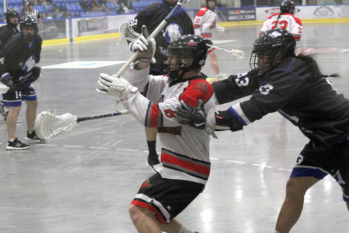 Nanaimo Timbermen player Colton Lidstone is checked by Langley Thunder opponent Aaron Skye during Game 2 of the Western Lacrosse Association finals on Sunday, Aug. 21, at Frank Crane Arena. (Greg Sakaki/News Bulletin)