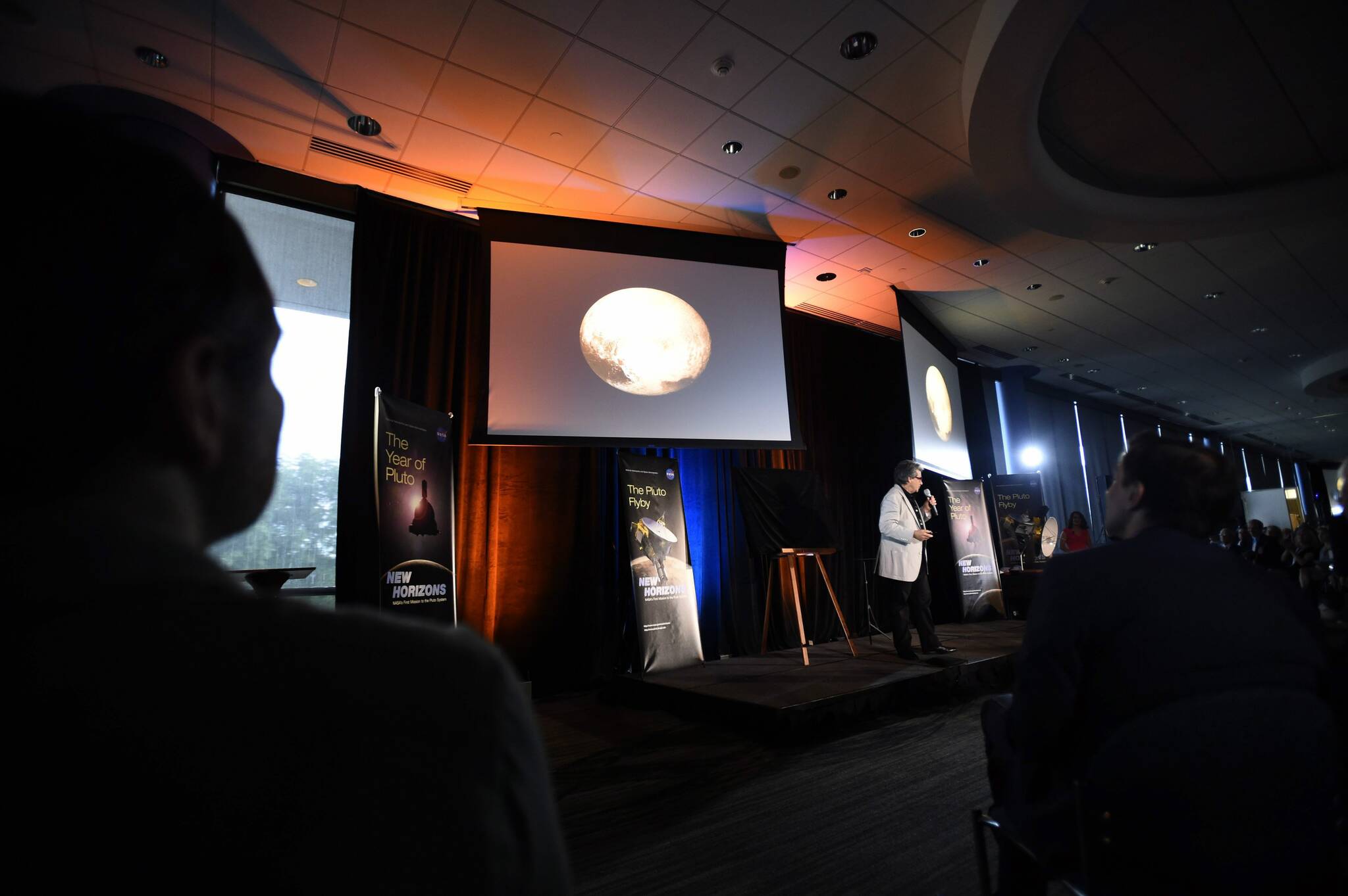 NASA employees and scientists await information from the New Horizons spacecraft as it passes Pluto, Tuesday, July 14, 2015, in Laurel, Md (AP Photo/Gail Burton)