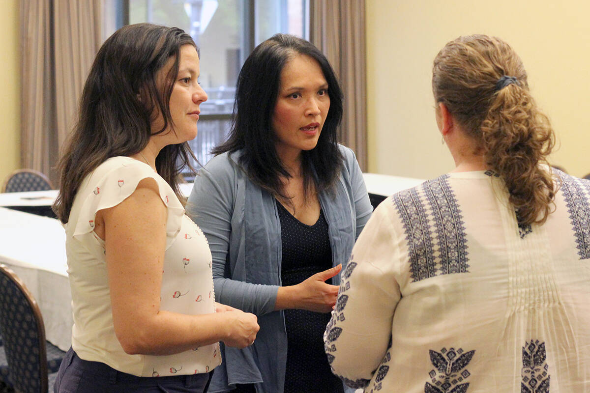 NDP MPs Lisa Marie Barron, left, and Jenny Kwan speak with Kirsten Brooker, program coordinator with Nanaimo Family Life Association, following a round-table discussion on affordable housing Friday, Aug. 19, at the Vancouver Island Conference Centre. (Greg Sakaki/News Bulletin)