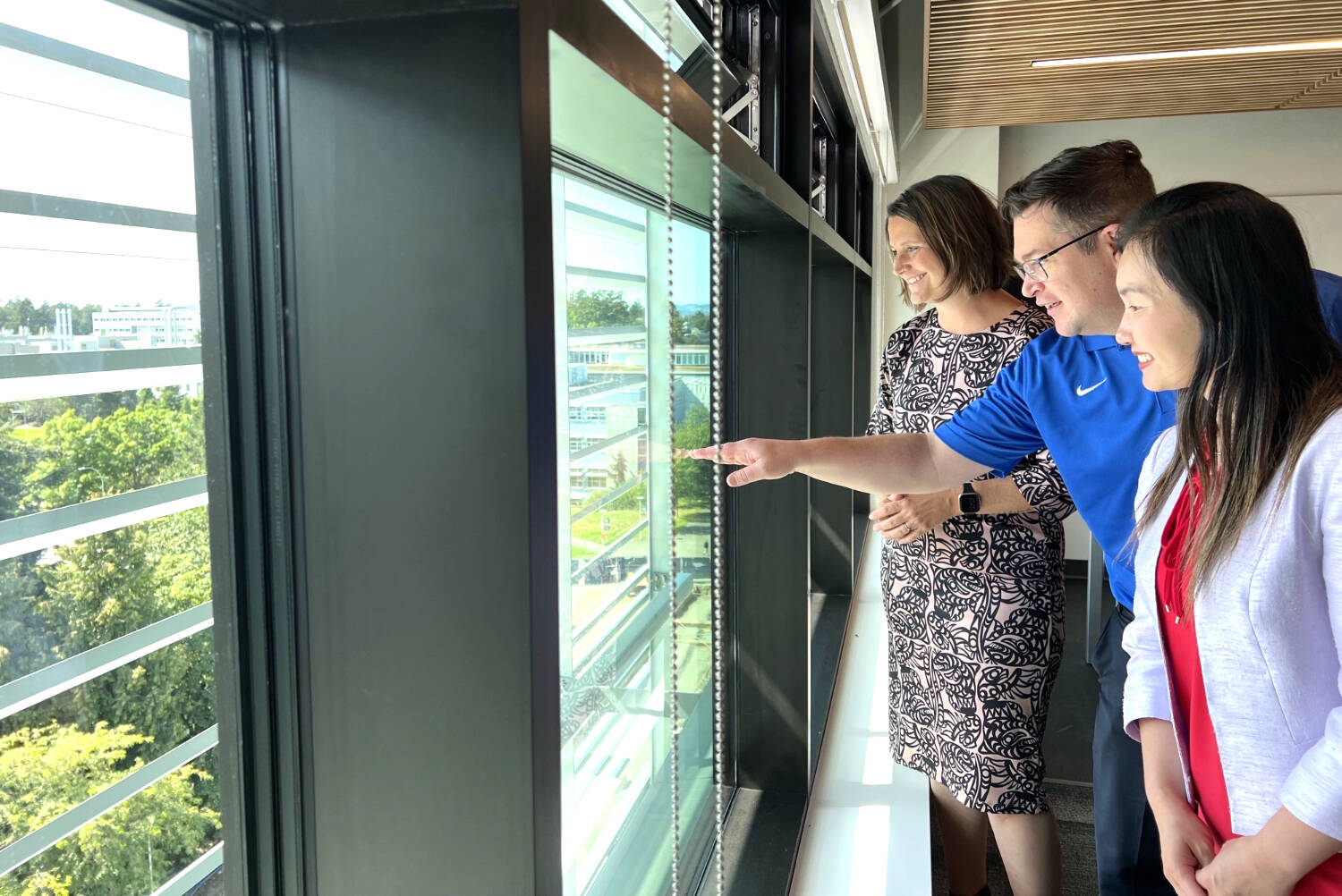 Victoria-Beacon Hill MLA Grace Lore, left, UVic board member Adam Monahan, and Minister of Advanced Education and Skills Training Anne Kang (right) check out the view from the new campus housing at the University of Victoria. (Courtesy Ministry of Advanced Education)