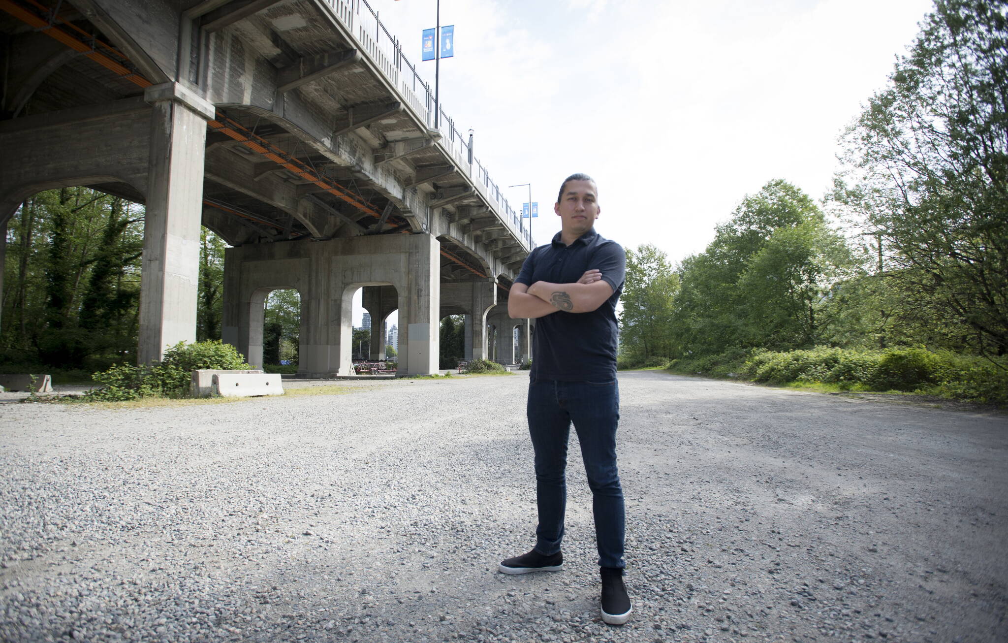 Dustin Rivers or Khelsilem, stands on the land below and next to the Burrard Street Bridge is pictured where the Squamish Nation is proposing a massive housing project in the city of Vancouver, Wednesday, May 1, 2019. THE CANADIAN PRESS/Jonathan Hayward