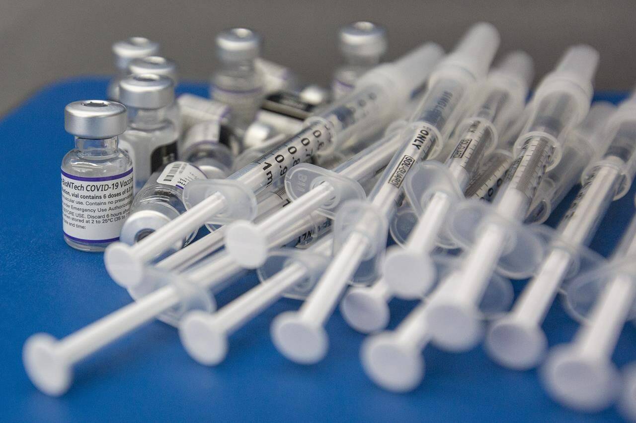 Syringes and vials of Pfizer-BioNTech COVID-19 vaccine are seen on a work surface during a drive through clinic at St. Lawrence College in Kingston, Ont., Saturday, Dec. 18, 2021. Health Canada approved Pfizer’s COVID-19 vaccine today for use in young children six months to four years old. THE CANADIAN PRESS/Lars Hagberg