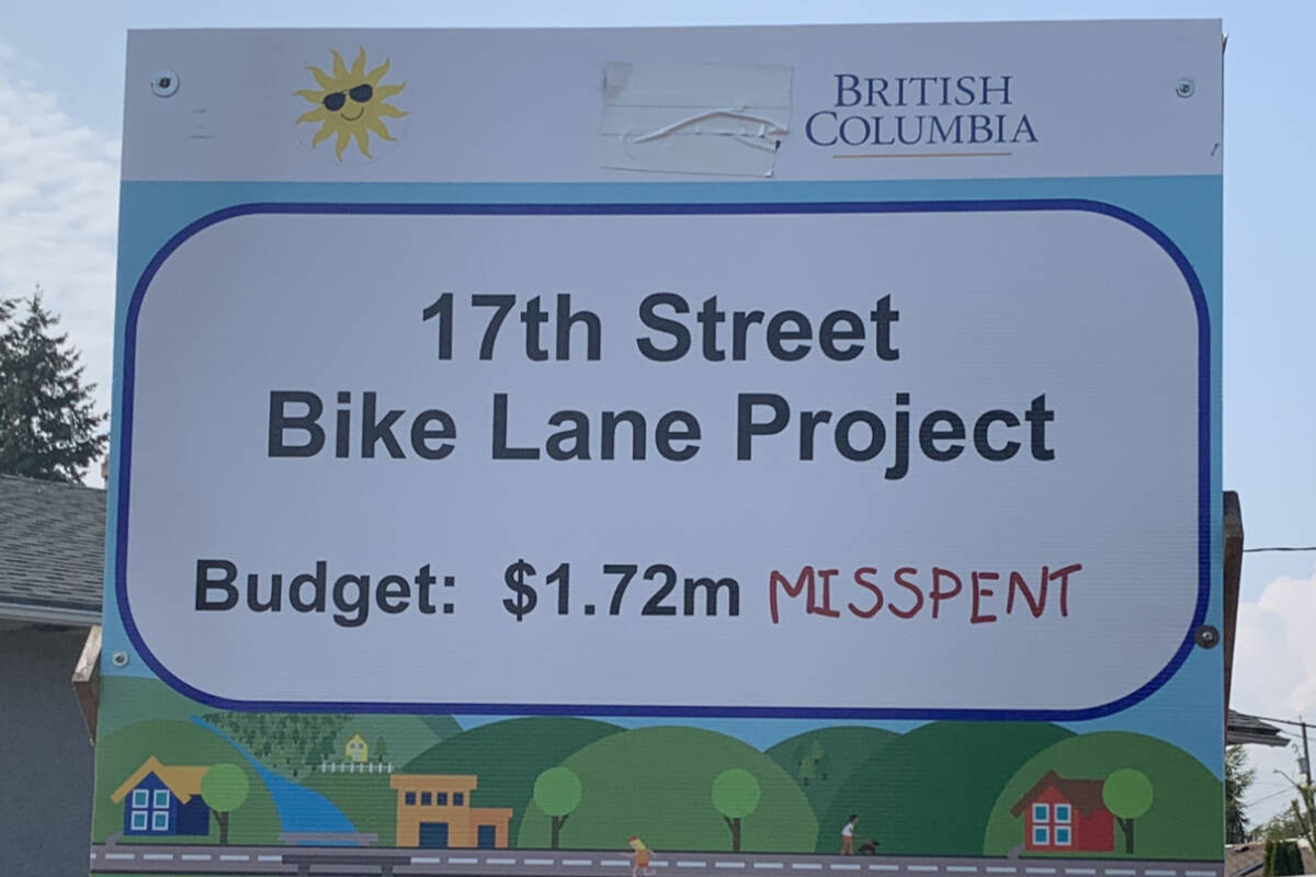This sign, at the beginning of the 17 Street (bike lane) Project, originally had the City of Courtenay logo on the top left-hand side (where the sun sticker is). The city’s chief election officer contacted Brennan Day to have the logo removed. Photo by Terry Farrell