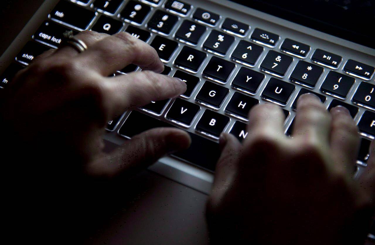 A woman uses her computer keyboard in North Vancouver, B.C., on December, 19, 2012. A new academic analysis has identified at least 75 foreign digital operations of a malicious political or industrial nature directed at Canada since 2010 – from attempts to steal COVID-19-related research to the targeting of Uyghur human rights activists. THE CANADIAN PRESS/Jonathan Hayward