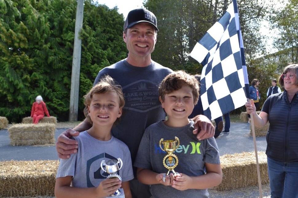 Brothers Dorian Baird, right, and Elliot placed first and second in the Tier B group with the helping hands of dad Mike.