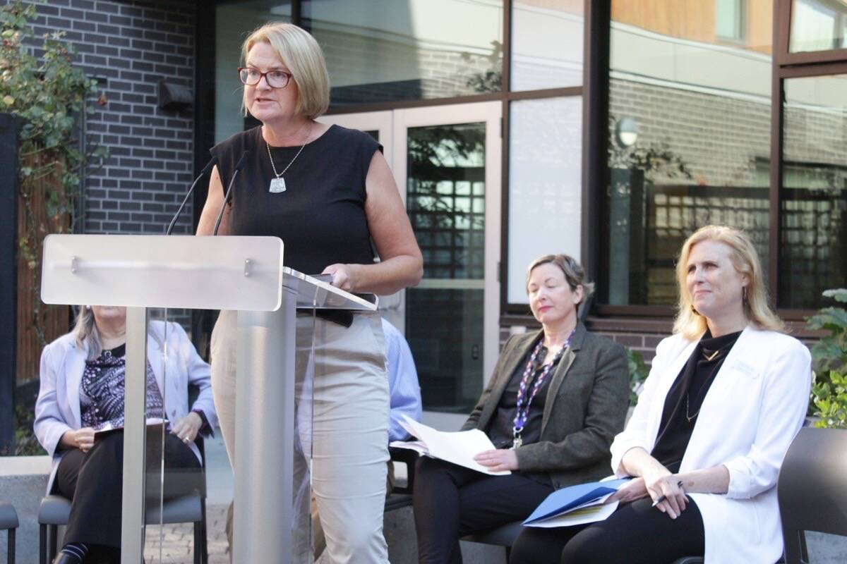 Corinne Saad, executive director of Gorge View Society, discusses the joint list of calls to action during a media event on Sept. 22 at the Camas Gardens Supportive Housing Site in Victoria. (Austin Westphal/News Staff)