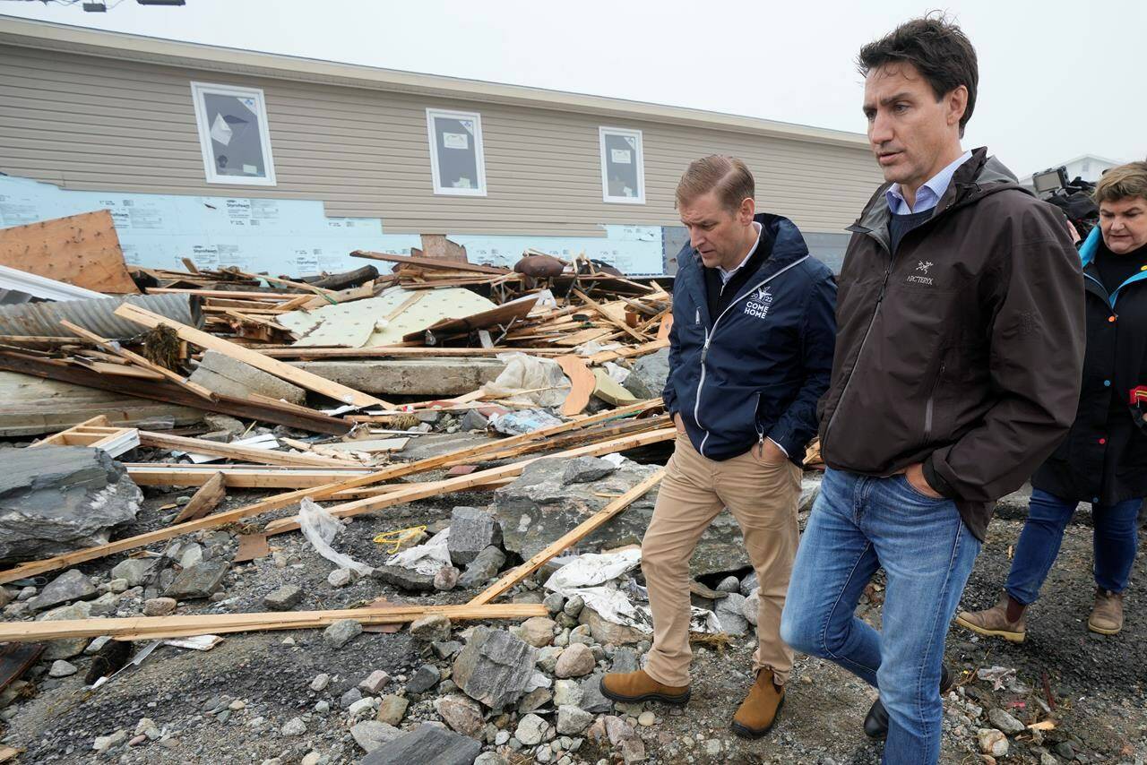 Prime Minister Justin Trudeau, right, and Newfoundland and Labrador Premier Andrew Furey tour the damage cause by post-tropical storm Fiona in Port aux Basques, N.L. on Wednesday, Sept. 28, 2022. THE CANADIAN PRESS/Frank Gunn