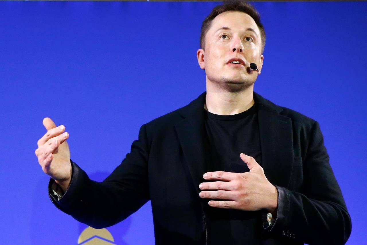 FILE - Tesla Motors, Inc. CEO Elon Musk speaks at the Paris Pantheon Sorbonne University as part of the COP21, United Nations Climate Change Conference in Paris on Dec. 2, 2015. An early prototype of Tesla Inc.'s proposed Optimus humanoid robot slowly and awkwardly walked onto a stage, turned, and waved to a cheering crowd at the company's artificial intelligence event Friday, Sept. 30, 2022. (AP Photo/Francois Mori, File)