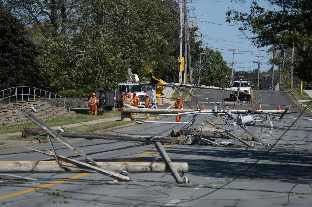 Workers assess downed power poles caused by post-tropical storm Fiona in Dartmouth, N.S., on Sunday, Sept. 25, 2022. Prime Minister Justin Trudeau has announced the creation of a $300-million fund to help with Atlantic Canada’s recovery from post-tropical storm Fiona. THE CANADIAN PRESS/Darren Calabrese