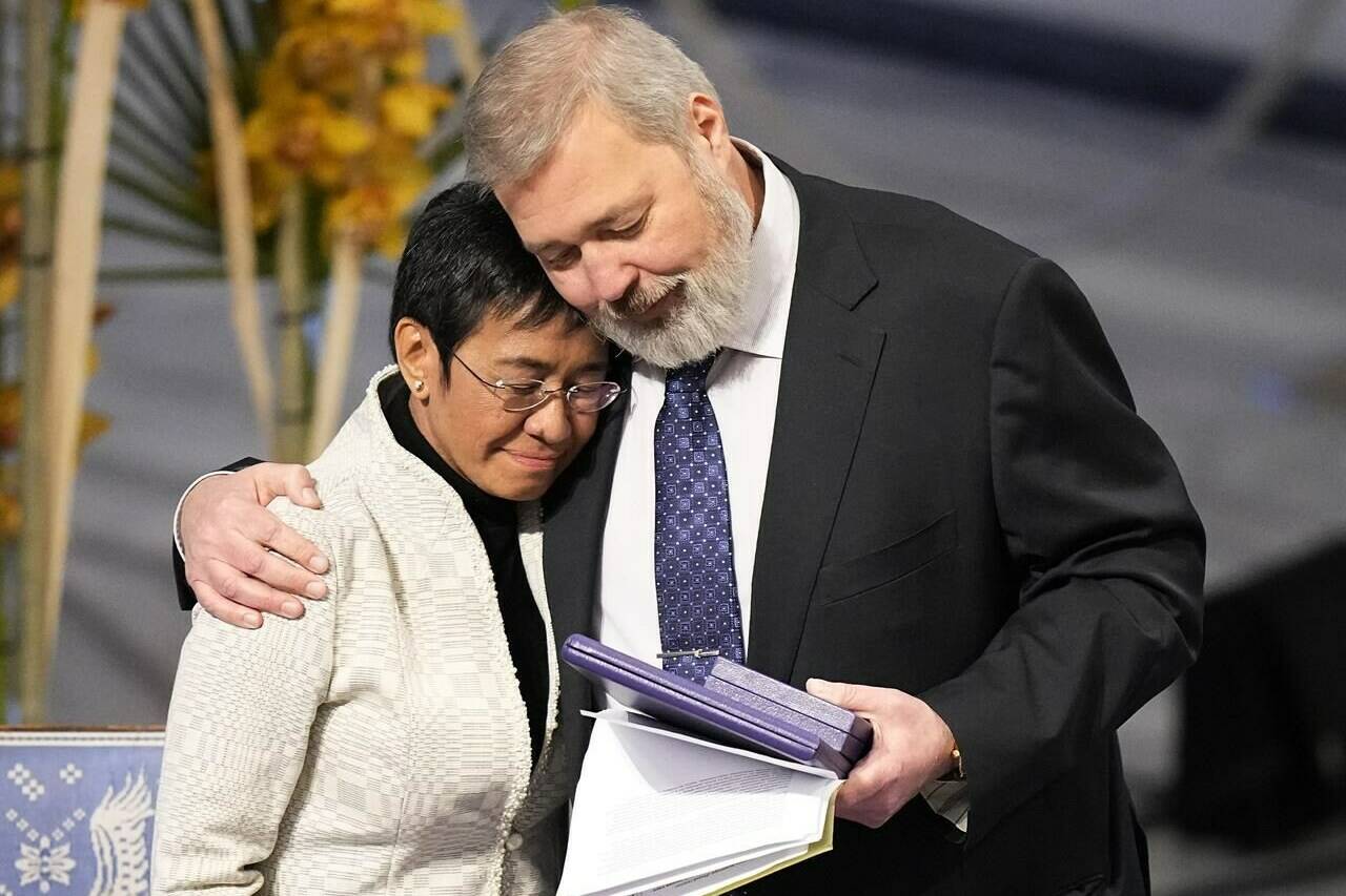 FILE - Nobel Peace Prize winners Dmitry Muratov from Russia, right, and Maria Ressa of the Philippines embrace during the Nobel Peace Prize ceremony at Oslo City Hall, Norway, Friday, Dec. 10, 2021. For the two journalists who won the Nobel Peace Prize in 2021, the past year has not been easy. Dmitry Muratov of Russia and Maria Ressa of the Philippines have been fighting for the survival of their news organizations, defying government efforts to silence them. (AP Photo/Alexander Zemlianichenko, File)