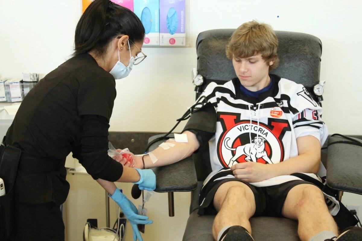 Victoria Cougars forward Ryan Comisky gives his blood for the first time at the Canadian Blood Services donation centre in Saanich. (Austin Westphal/News Staff)