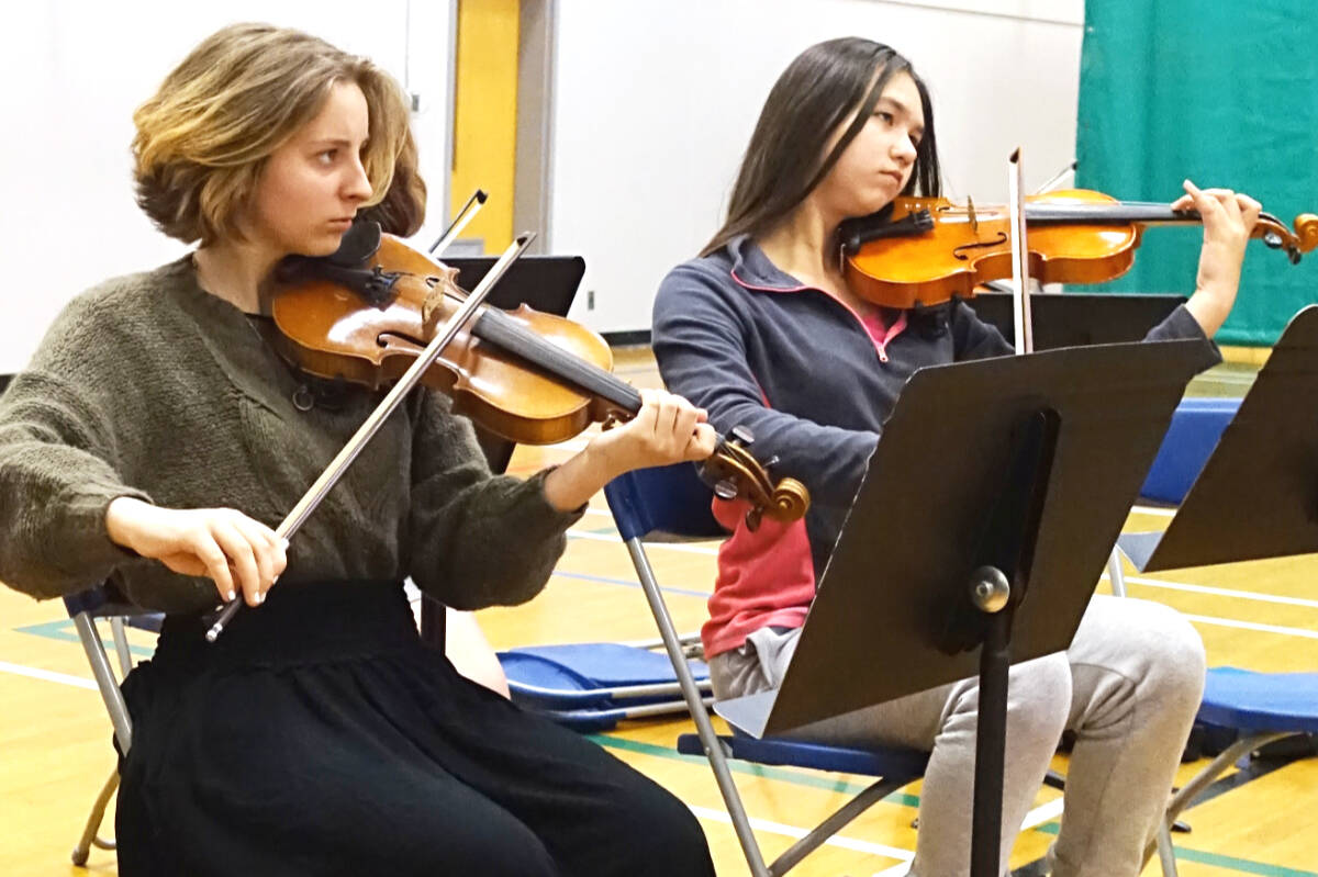 Evy Miller and Leah Paquett practice with the Harmony Project Sooke string class. The pair were the among the first students in the program. (Contributed – Harmony Project Sooke)