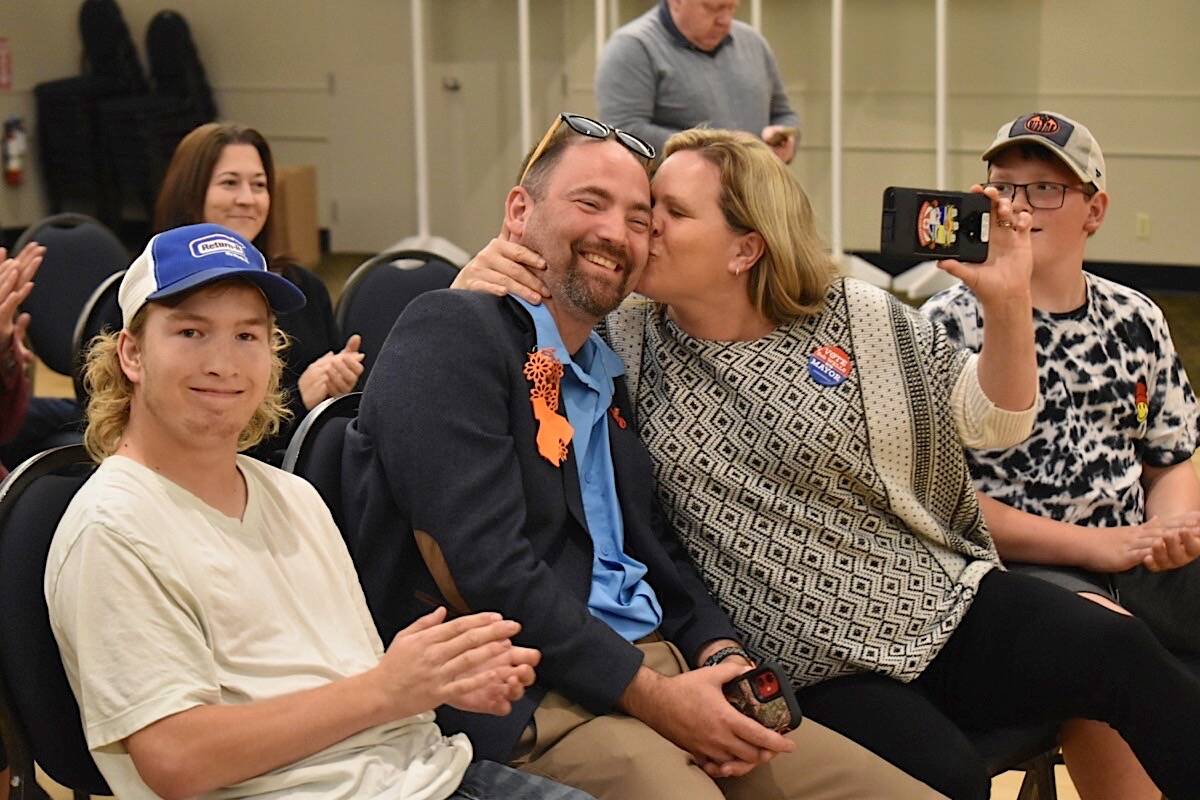 Courtenay Mayor Bob Wells receives a kiss from his wife Michelle after hearing the election results, Saturday at the Filberg Centre. Wells has been elected to his second term as mayor. Scott Stanfield photo