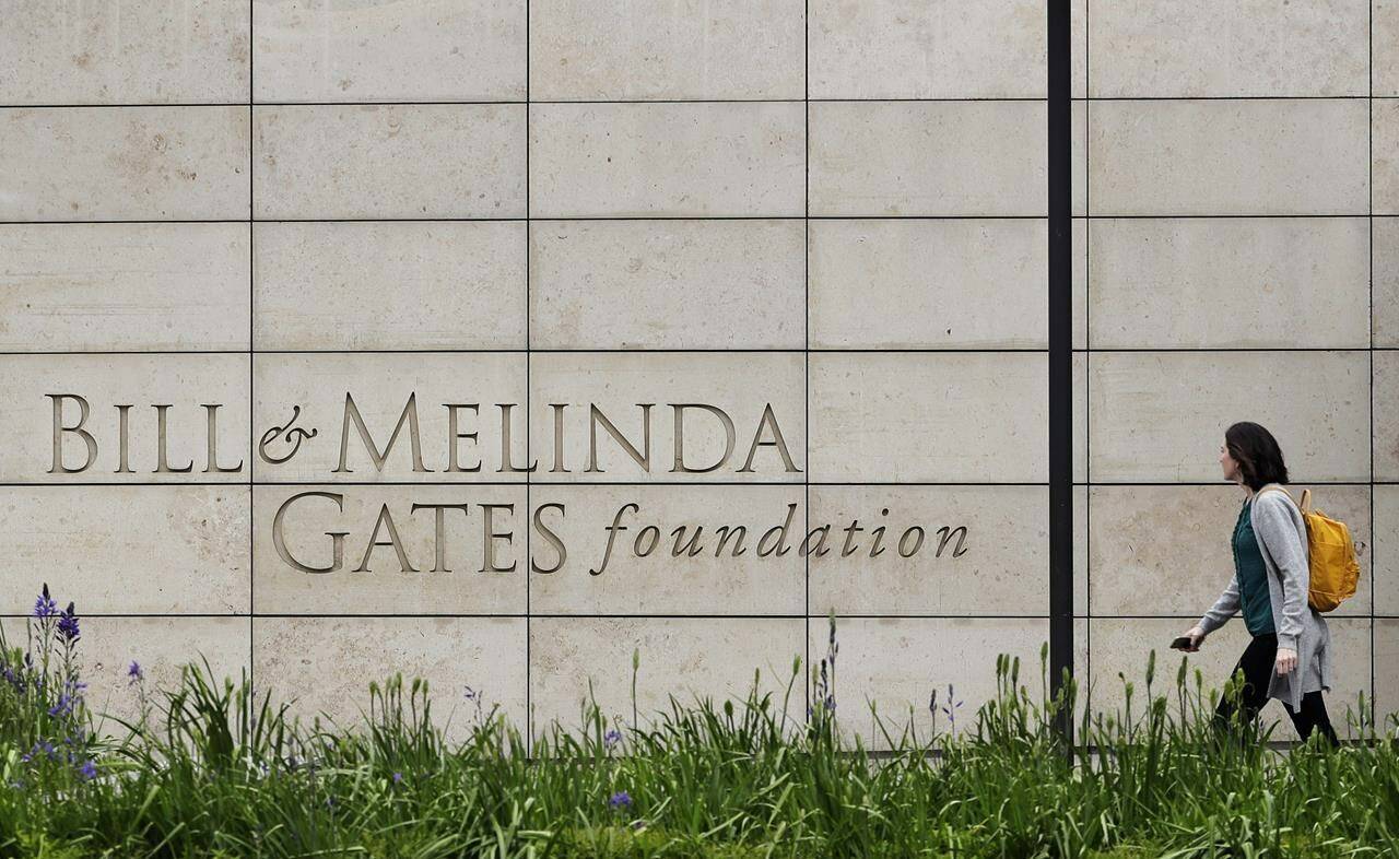 FILE - A person walks by the headquarters of the Bill and Melinda Gates Foundation on April 27, 2018, in Seattle. The Bill and Melinda Gates Foundation announced Sunday, Oct. 16, 2022, that it will commit $1.2 billion to the effort to end polio worldwide. (AP Photo/Ted S. Warren, File)
