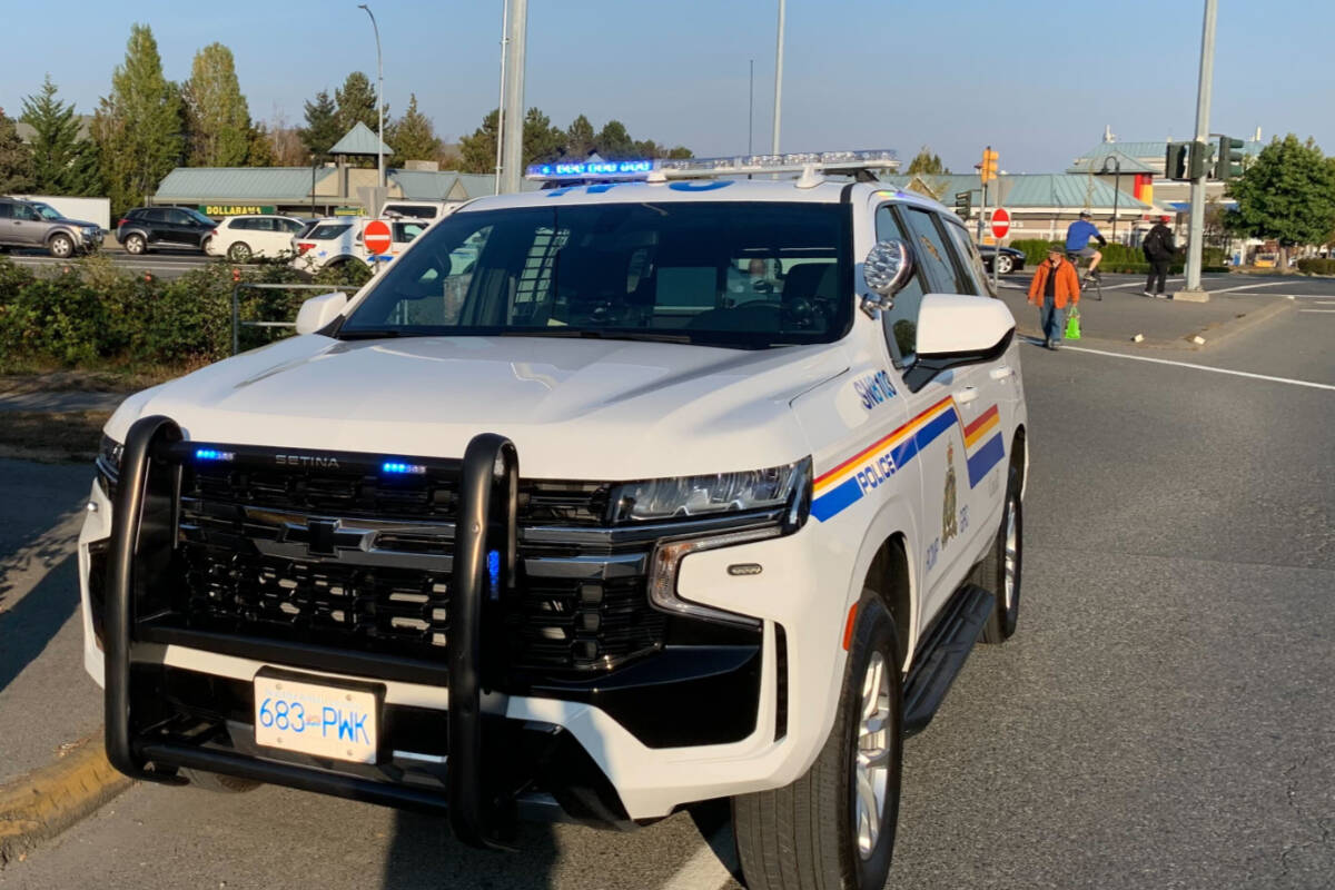 Several Sidney/North Saanich RCMP vehicles and officers at Beacon Avenue and Highway 17 on Oct. 13 around 4:30 p.m. for what turned out to be a false alarm. (Wolf Depner/News Staff)