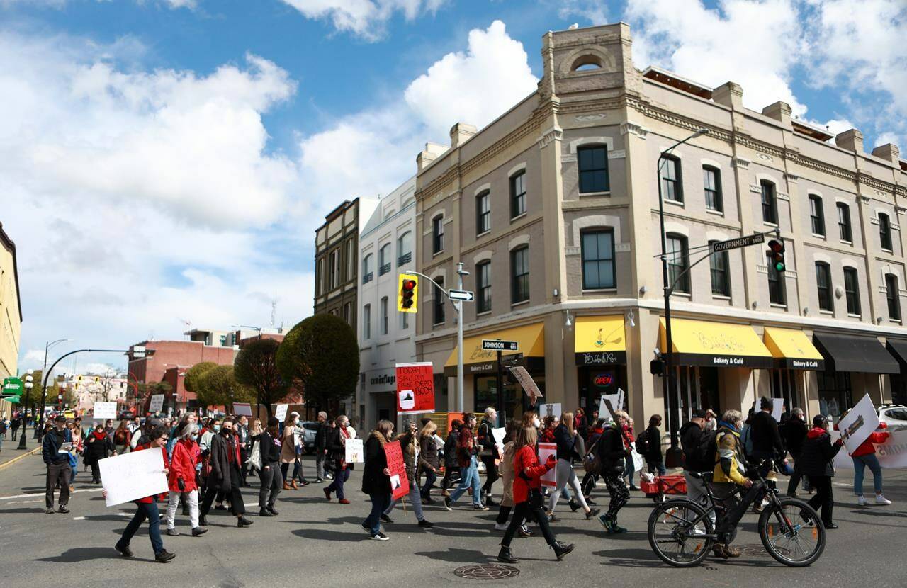 Moms Stop the Harm advocates and supporters march from Centennial Square to the Ministry of Health building on the sixth anniversary to mark the public health emergency of the declaration due to the significant increase in opioid-related overdose across the province during the Cut The Red Tape theme in Victoria on Thursday, April 14, 2022. THE CANADIAN PRESS/Chad Hipolito