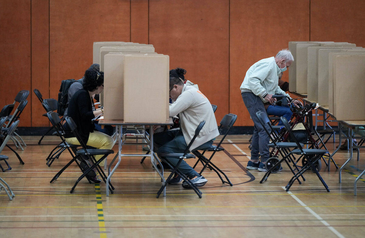 Voters mark their civic election ballots at a polling station in Vancouver, on Saturday, October 15, 2022. THE CANADIAN PRESS/Darryl Dyck